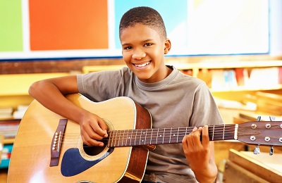 child holding guitar